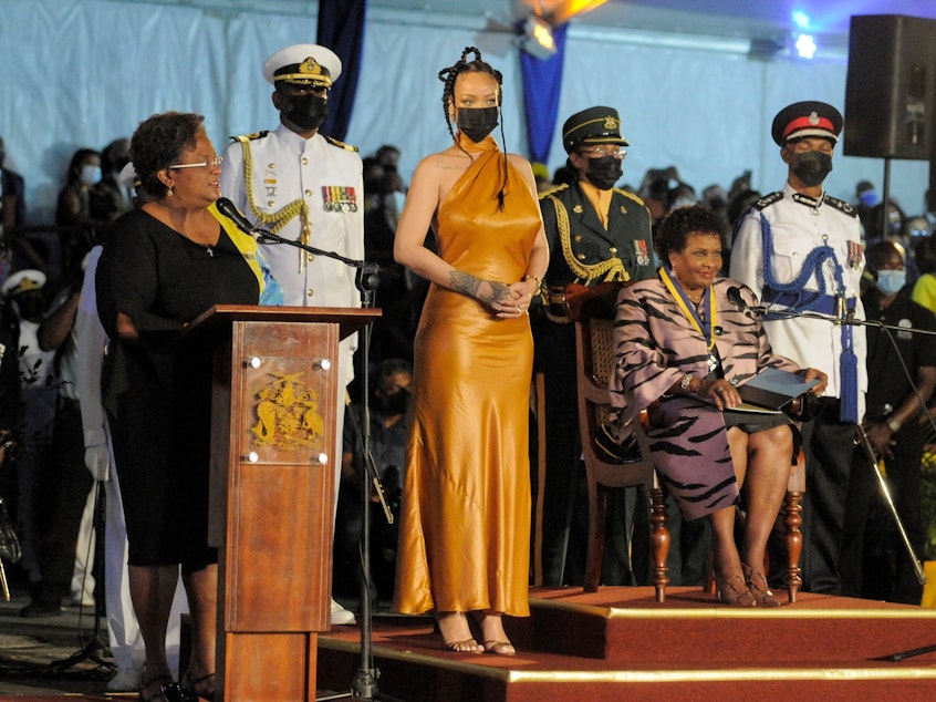 caption: Barbados's Prime Minister Mia Mottley, left, asks the country's new president, Sandra Mason, seated at right, to make Barbadian singer Rihanna the country's 11th National Hero during a ceremony to declare Barbados a republic Tuesday.