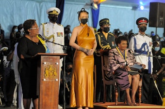 caption: Barbados's Prime Minister Mia Mottley, left, asks the country's new president, Sandra Mason, seated at right, to make Barbadian singer Rihanna the country's 11th National Hero during a ceremony to declare Barbados a republic Tuesday.
