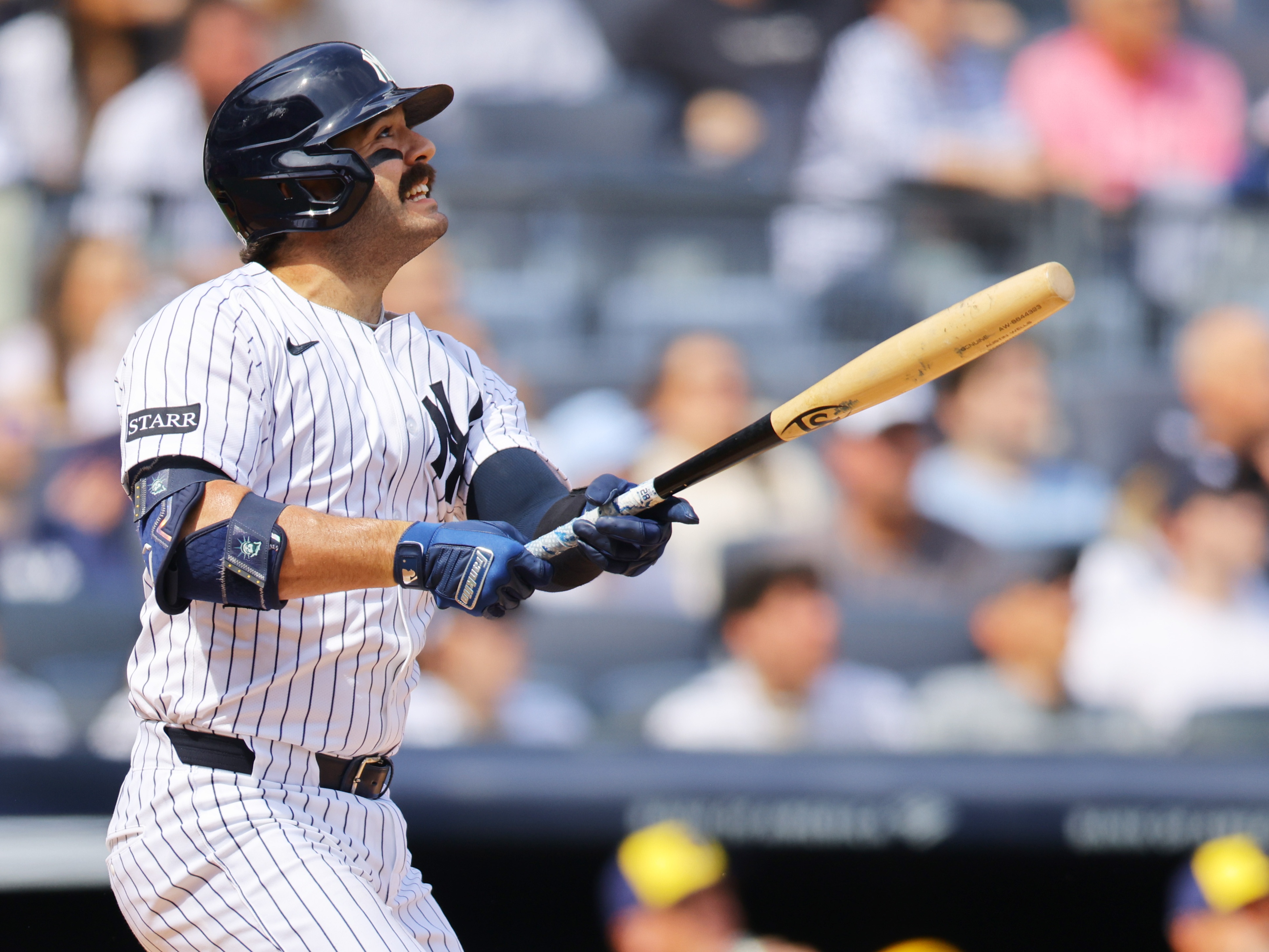 caption: The New York Yankees' Austin Wells hits a home run using a torpedo bat against the Milwaukee Brewers at Yankee Stadium on Saturday. The bats' distinctive shape quickly became the talk of the new baseball season.