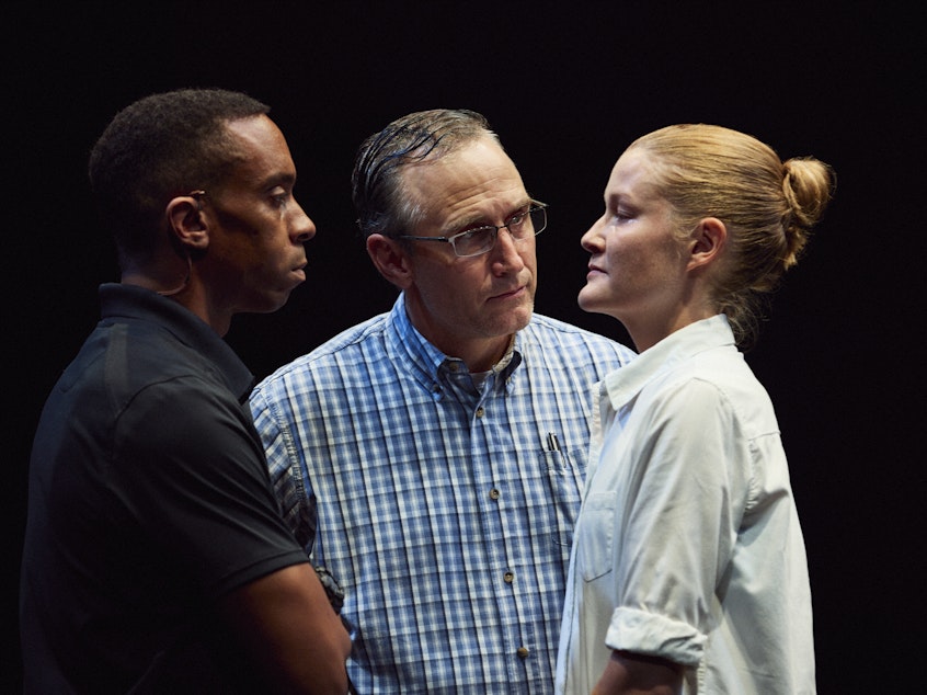 caption: Will Cobbs and Pete Simpson play FBI agents interrogating Emily Davis's Reality Winner, in <em>Is This</em><em> a Room.</em>