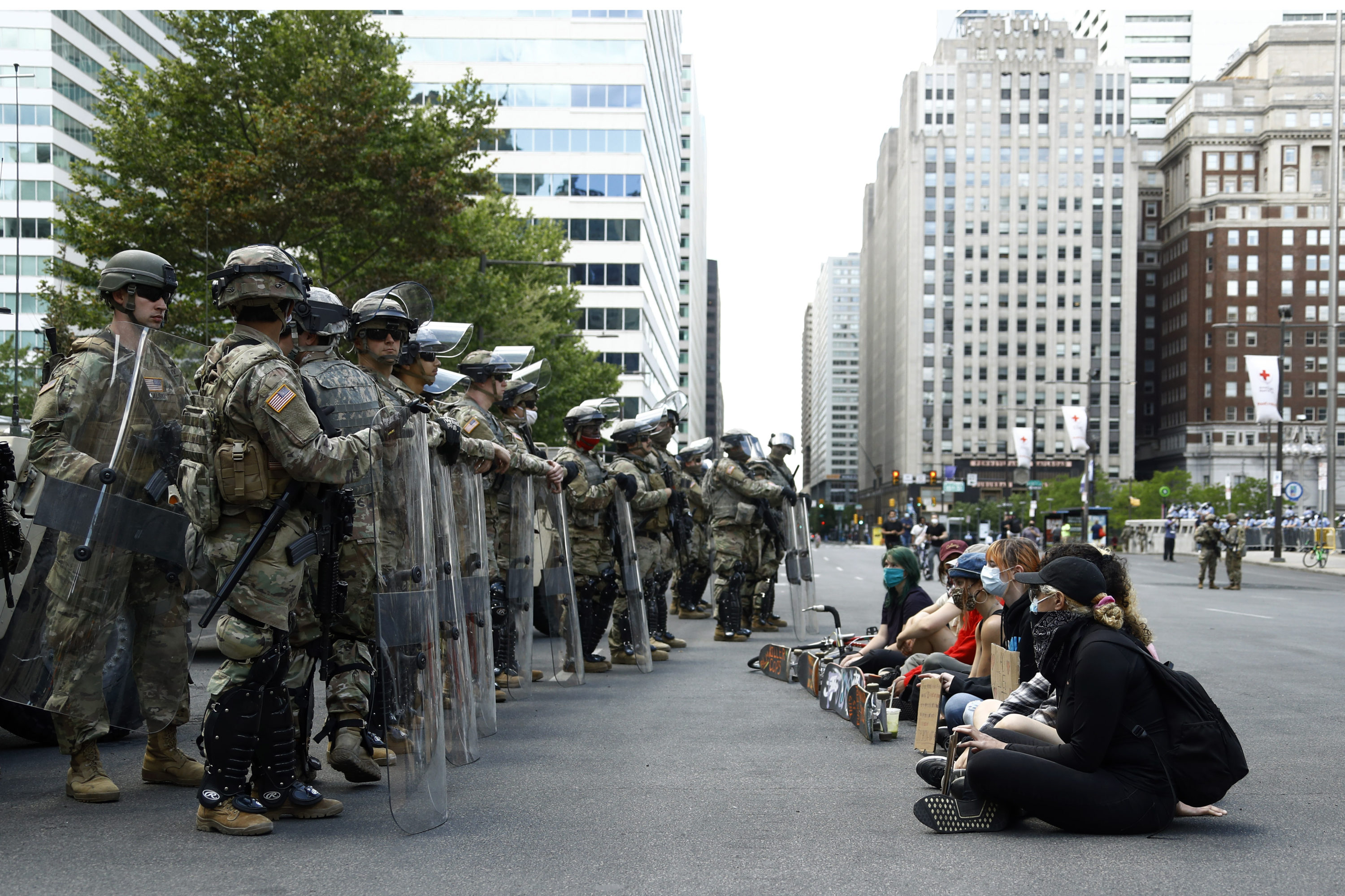 caption: Protesters rally in front of Pennsylvania National Guard soldiers, Monday, June 1, 2020, in Philadelphia, over the death of George Floyd, a black man who was in police custody in Minneapolis. (Matt Slocum/AP Photo)