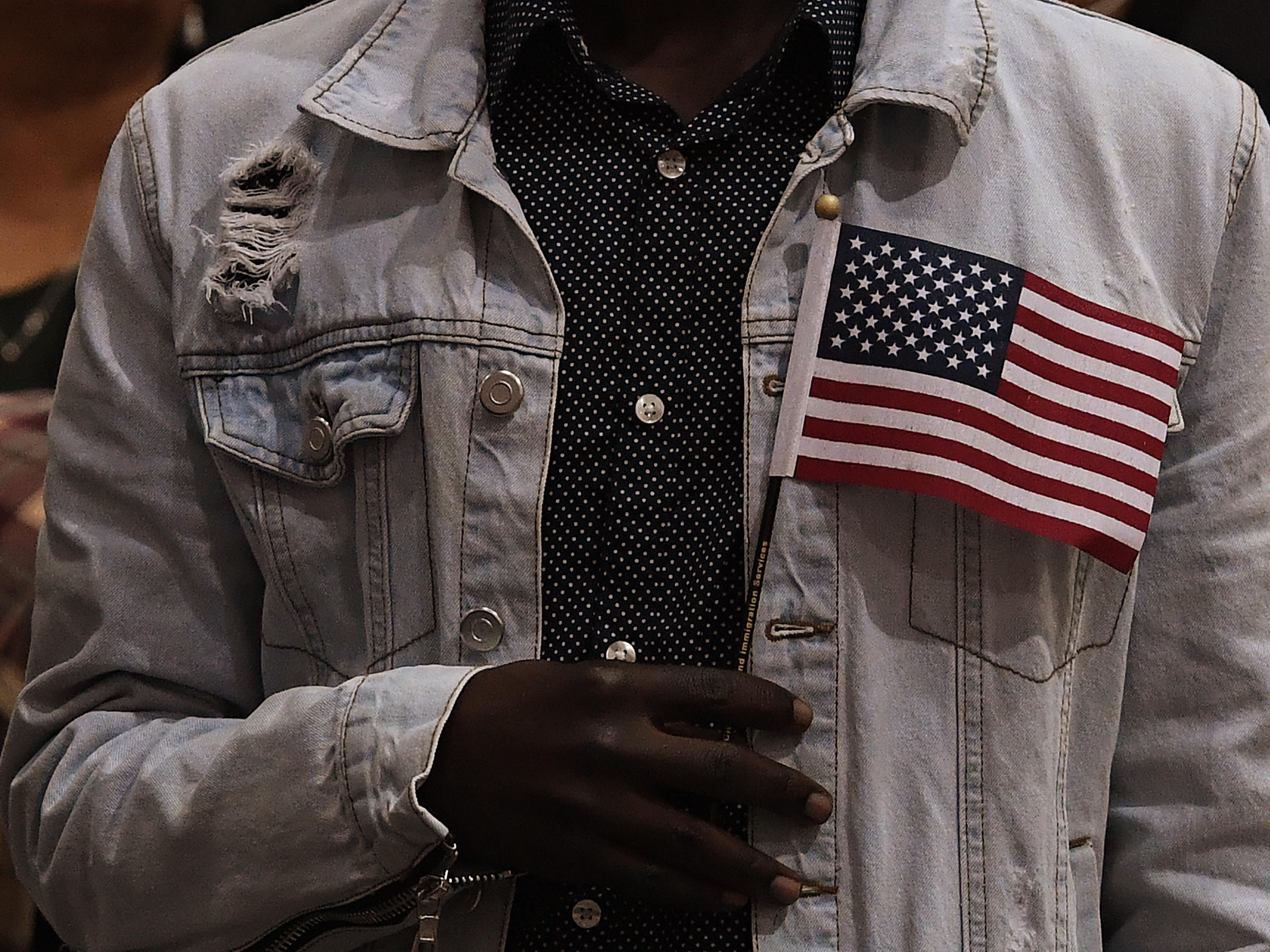 caption: People pledge allegiance to America as they receive U.S. citizenship at a naturalization ceremony for immigrants in Los Angeles in 2017.