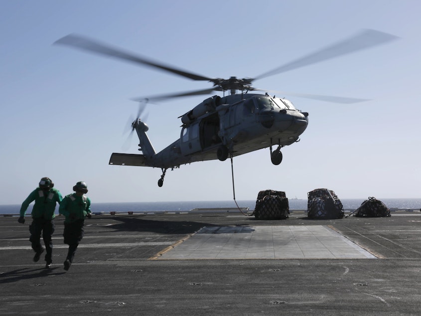 caption: An MH-60S Sea Hawk helicopter takes off from the aircraft carrier USS Abraham Lincoln in the Red Sea. The Abraham Lincoln Carrier Strike Group was recently deployed to the U.S. Central Command area of responsibility as tensions between the U.S. and Iran escalate. On Monday, the State Department ordered additional troops to the Middle East.