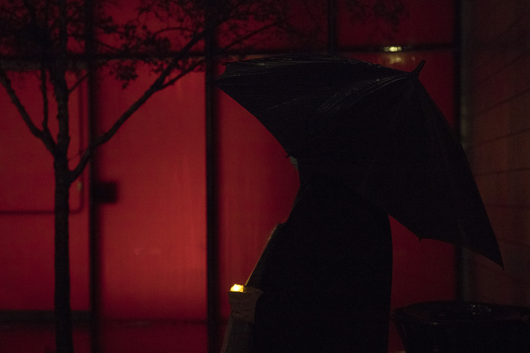 caption: Peter Lewis holds a candle during the WHEEL Women in Black Vigil for the record-breaking 139 homeless people who’ve died outside, in public or by violence this year in King County, on Monday, December 21, 2020, at Seattle City Hall. 