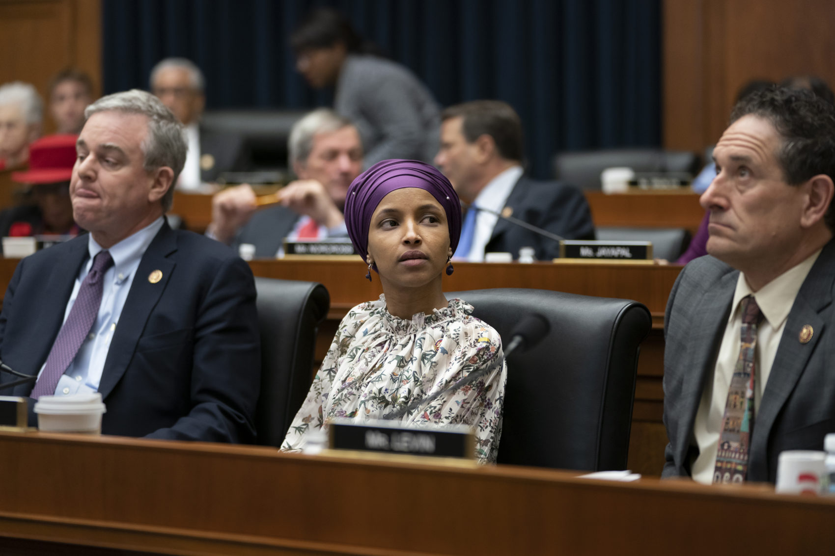 caption: Rep. Ilhan Omar, D-Minn., sits with fellow Democrats, Rep. David Trone, D-Md., left, and Rep. Andy Levin, D-Mich., right, on the House Education and Labor Committee during a bill markup, on Capitol Hill in Washington, Wednesday, March 6, 2019. (J. Scott Applewhite/AP)