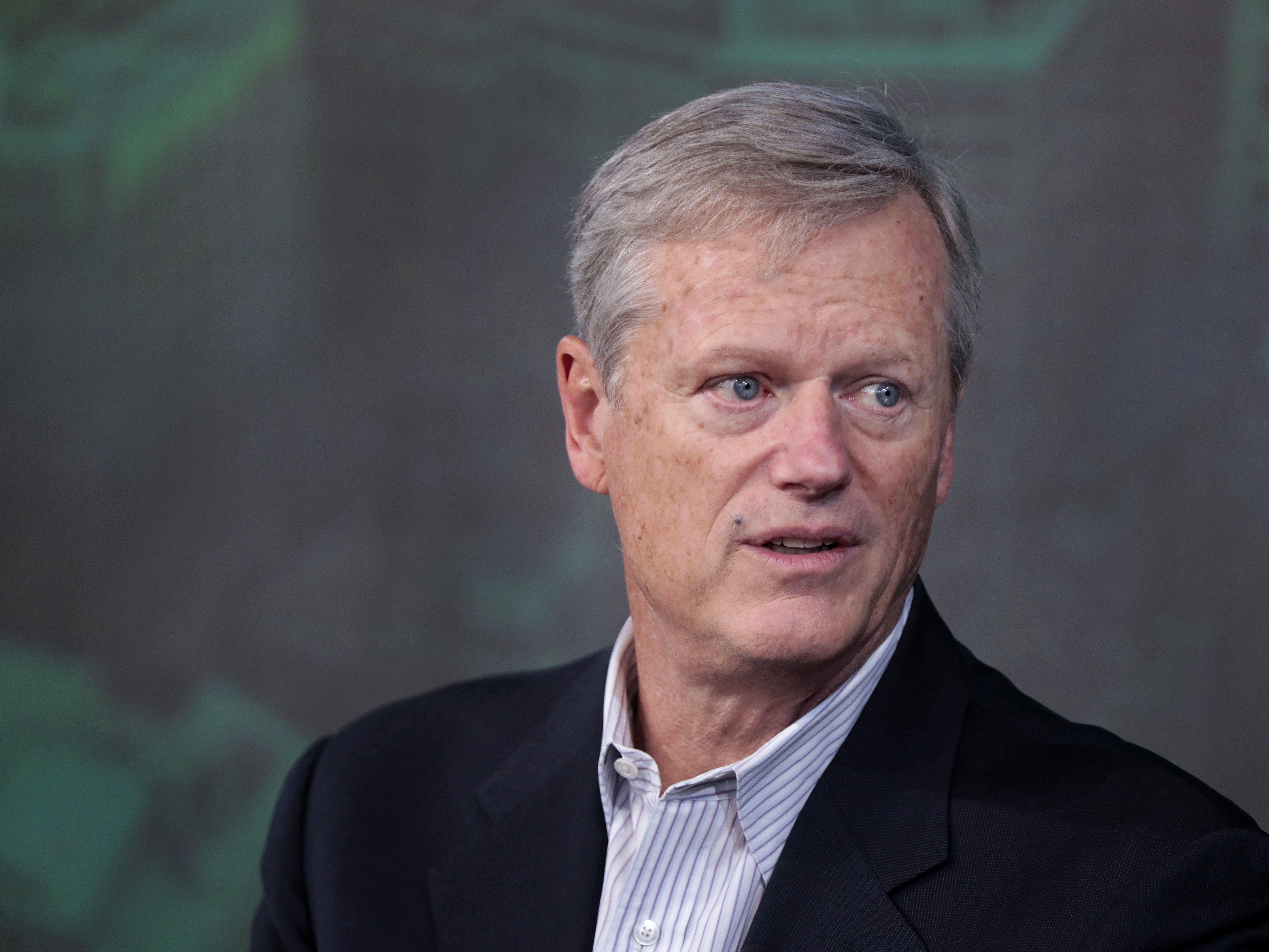 caption: NCAA president and former Massachusetts governor Charlie Baker is interviewed by Boston Globe Sports writer Chris Gasper at the Globe Summit 2023.