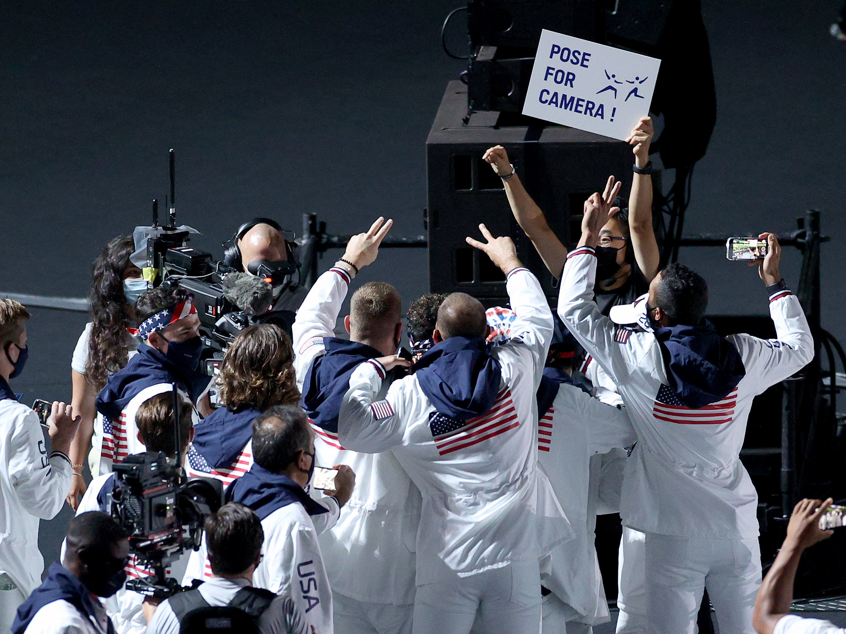 caption: Members of the U.S. team pose for NBC cameras during the closing ceremony on Sunday.