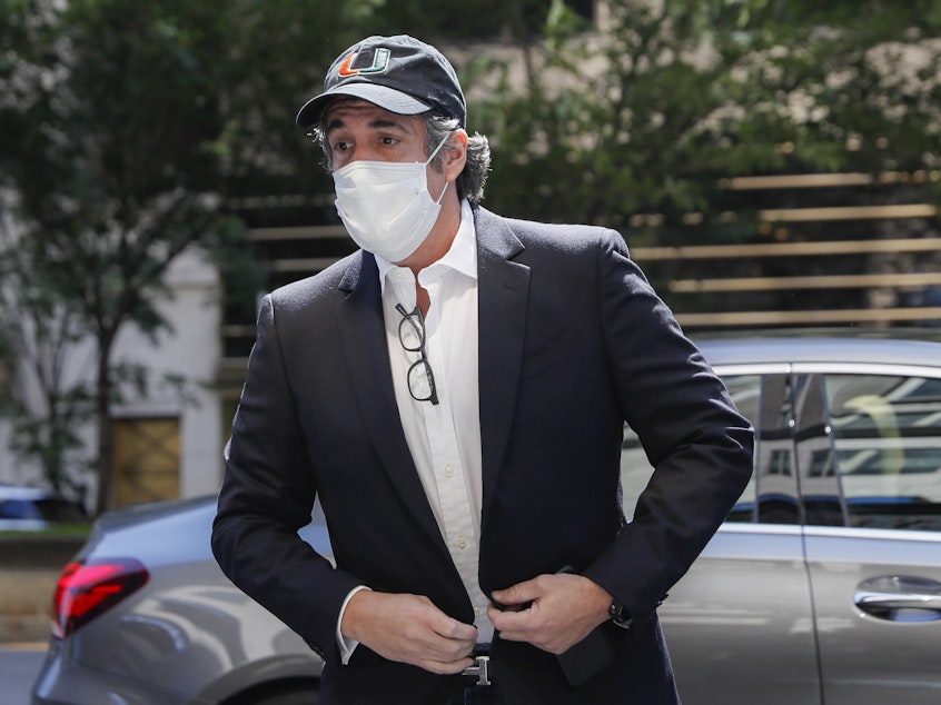 caption: Michael Cohen arrives Thursday at his Manhattan apartment after being released from federal prison.