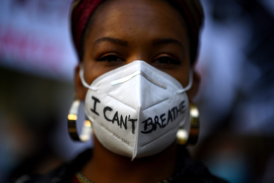 caption: A woman wears a mask reading "I can't breathe" in Madrid, on June 7, 2020, during a demonstration against racism and in solidarity with the Black Lives Matter movement, in the wake of the killing of George Floyd. (GABRIEL BOUYS/AFP via Getty Images)