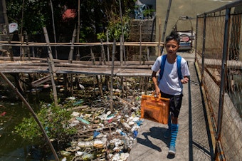 caption: Around the globe, people are searching for ways to reduce plastic waste. Above: Dampalit, a fishing community in Manila Bay, can't keep up with a constant influx of trash.