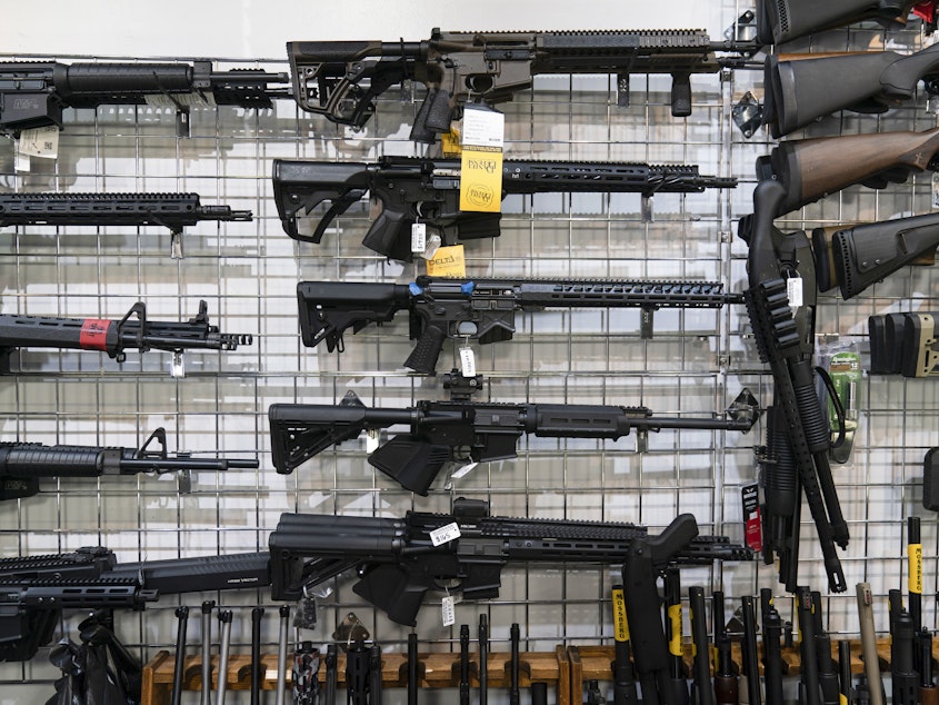 caption: AR-15-style rifles are on display at Burbank Ammo & Guns in Burbank, Calif., in June.