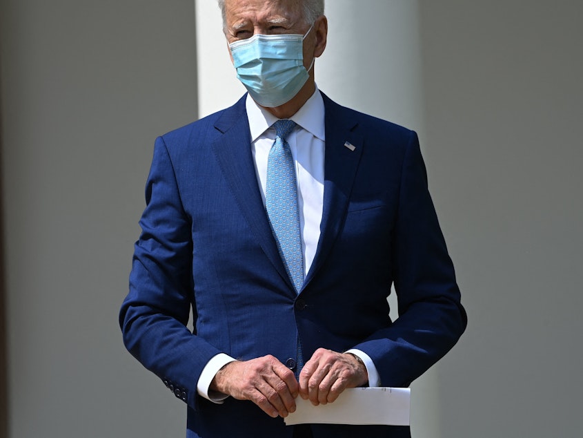 caption: President Biden looks on after speaking during an event about gun violence prevention in the Rose Garden of the White House on April 8.