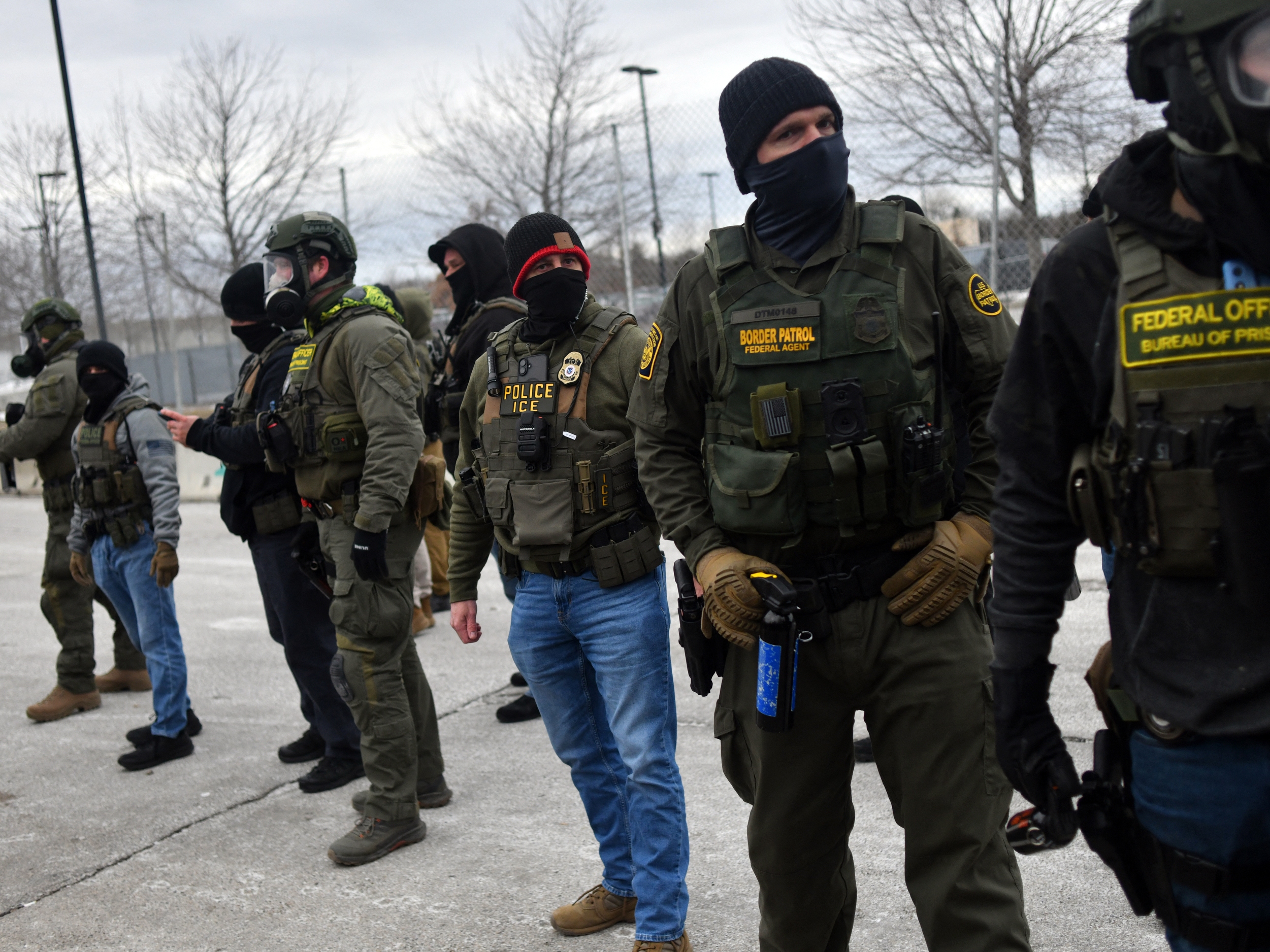 caption: Federal law enforcement agents confront protesters during a demonstration outside the Bishop Whipple Federal Building in Minneapolis, Minnesota, on Thursday.