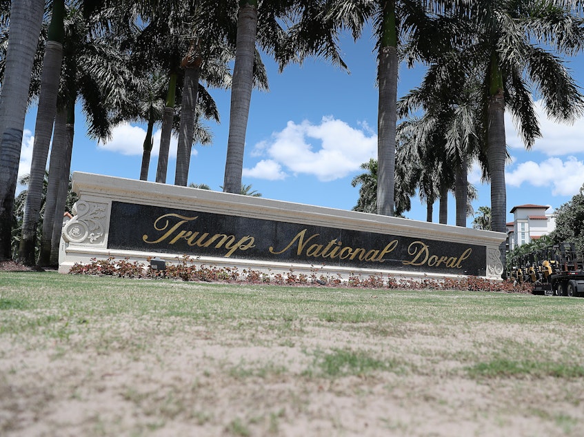 caption: The entrance to the Trump National Doral golf resort just outside of Miami. President Trump's continued ownership and promotion of his resorts while serving in office has been controversial and is the subject of multiple investigations and lawsuits.