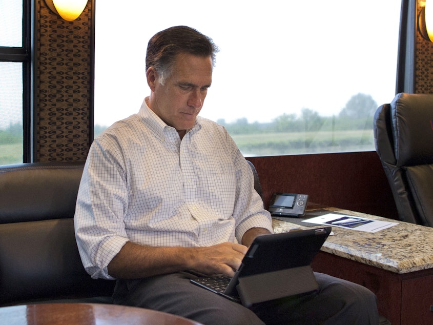 caption: Mitt Romney, pictured riding on his campaign bus through Iowa during his 2012 presidential bid, has admitted to using a pseudonym on Twitter.