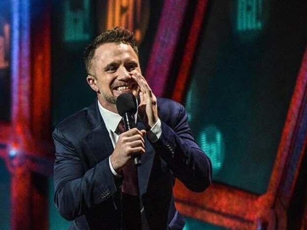 caption: Stand-up comedian D.J. Demers is hard of hearing. To reach others in the deaf community, his shows often include a sign language interpreter. Jennifer Lees (left) has interpreted many of his shows.