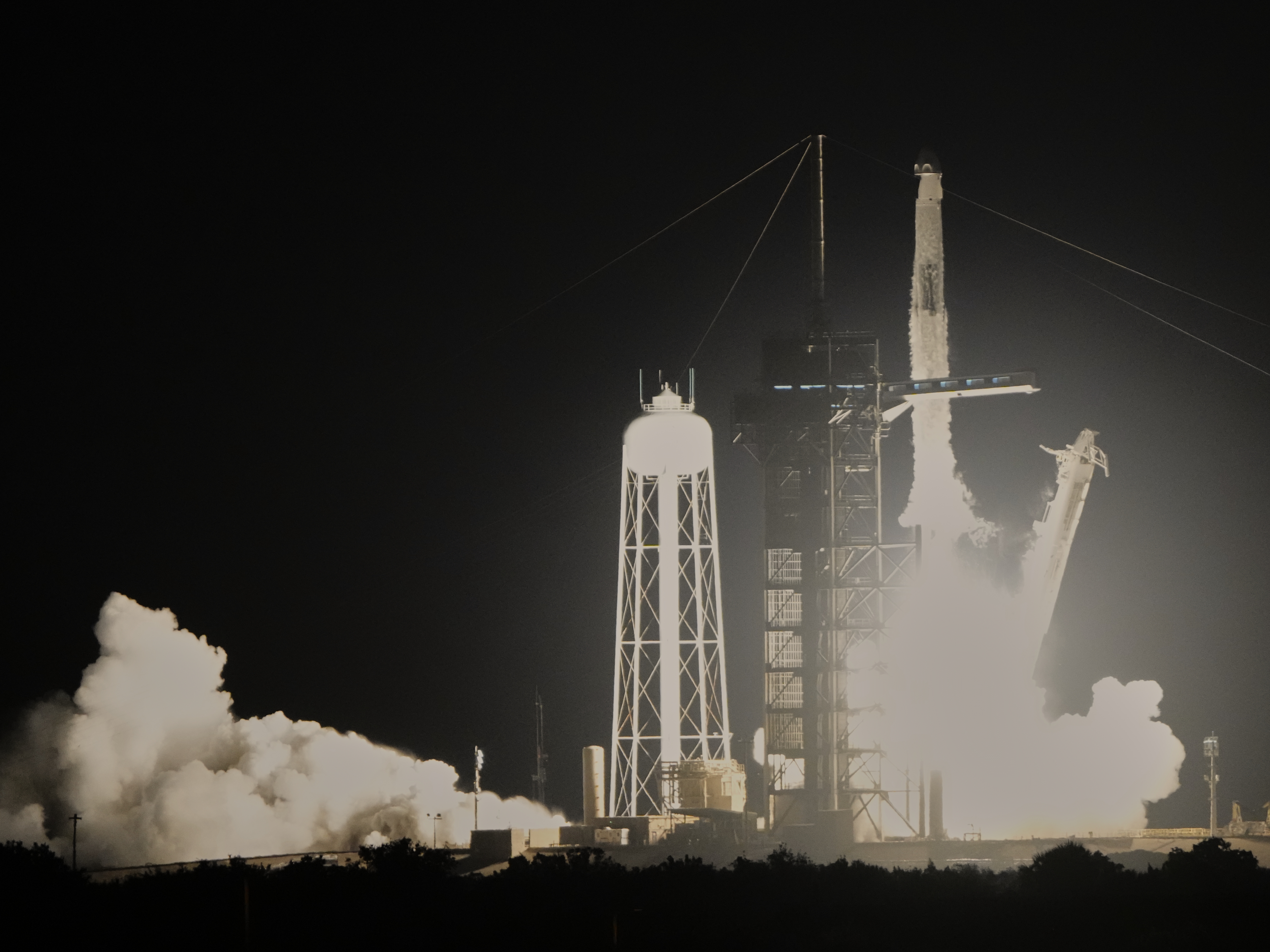 caption: A SpaceX Falcon 9 rocket launches a Crew Dragon capsule from NASA's Kennedy Space Center in Florida on Wednesday. The Ax-4 mission is the fourth private spaceflight for the Houston-based commercial company, which is flying four astronauts on a two-week trip to the International Space Station.