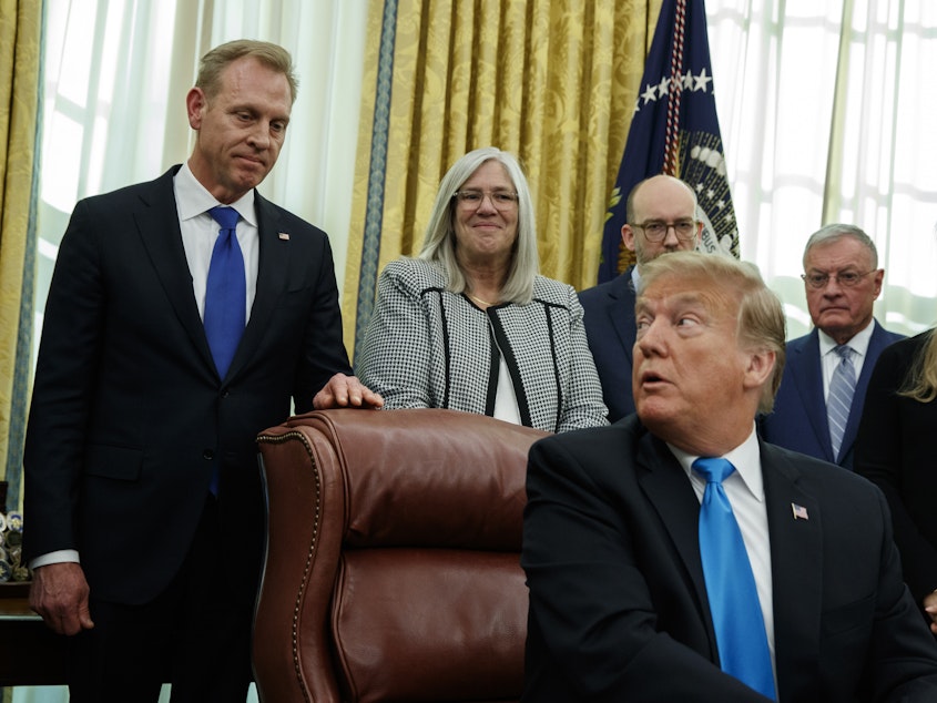 caption: Acting Secretary of Defense Patrick Shanahan listens as President Trump speaks during a signing event for Space Policy Directive 4 in the Oval Office last month.