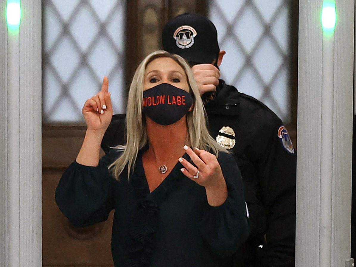 caption: Rep. Marjorie Taylor Greene, R-Ga., yells at journalists after setting off the metal detector outside the doors to the House of Representatives Chamber on Jan. 12. Twitter suspended the newly elected lawmaker's account temporarily on Sunday.