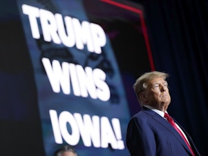 caption: Republican presidential candidate former President Donald Trump speaks at a caucus night party in Des Moines, Iowa on Monday.