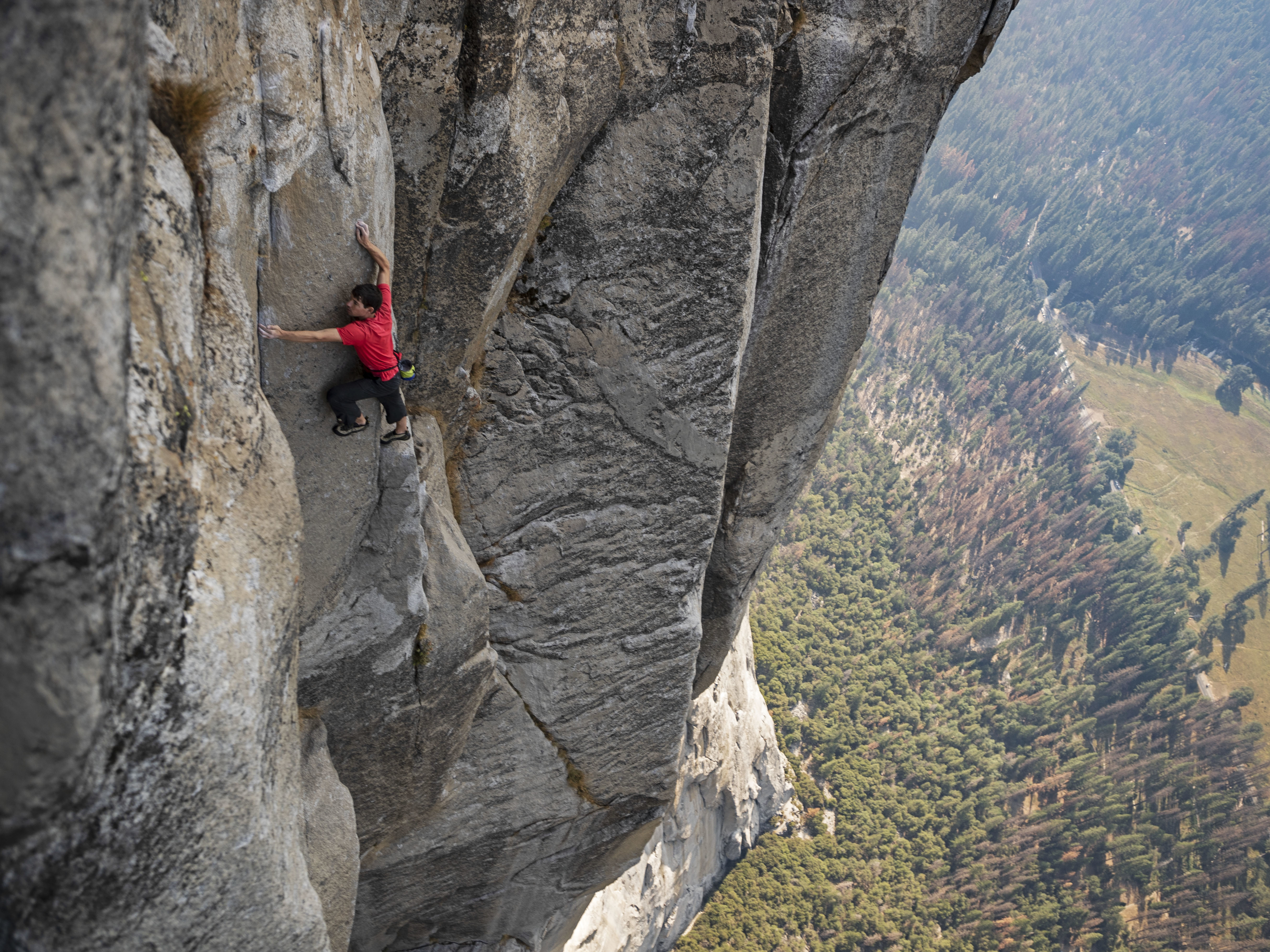 caption: Alex Honnold's ascent of El Capitan in Yosemite National Park — without ropes or safety equipment — was the subject of the documentary film <em>Free Solo.</em>