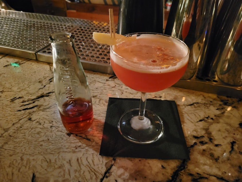 caption: The "Lightning Bug" at Herb & Bitter, a non-alcoholic beverage, made with spiritless tequila and Sanbitter soda, rather than Mezcal and Campari.