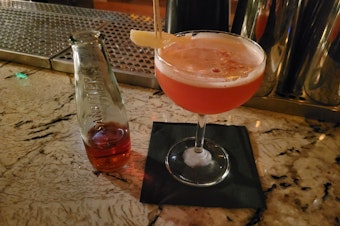 caption: The "Lightning Bug" at Herb & Bitter, a non-alcoholic beverage, made with spiritless tequila and Sanbitter soda, rather than Mezcal and Campari.