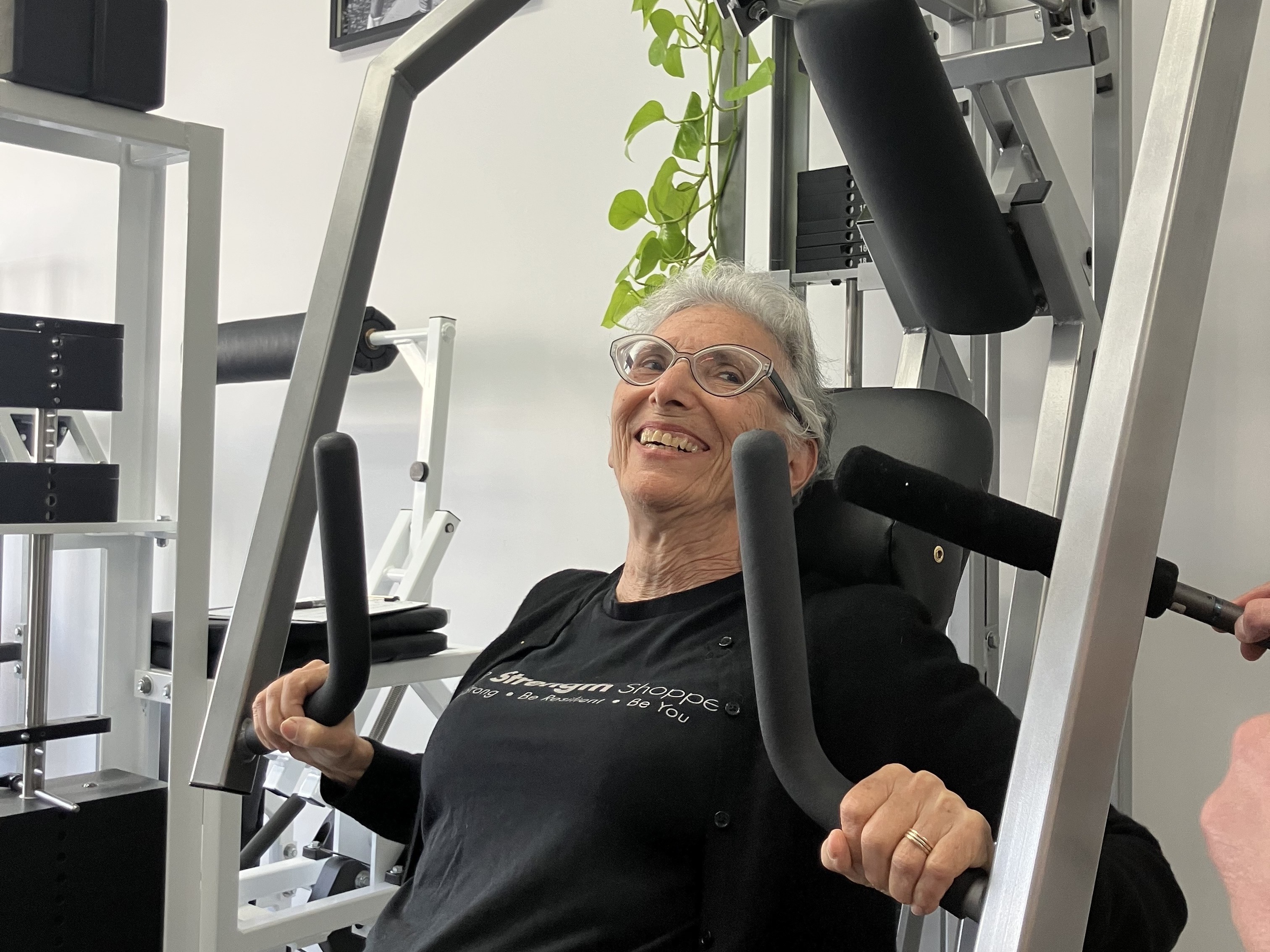 caption: 74-year-old Gilda Hass uses a chest press during her weekly workout at the Strength Shoppe in Los Angeles.