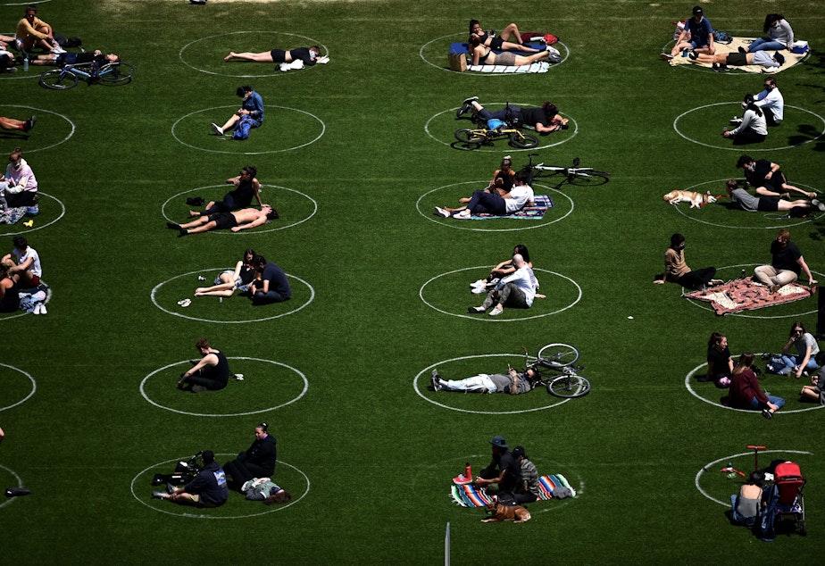 caption: People are seen social distancing in Brooklyn. (Johannes Eisele/AFP via Getty Images)