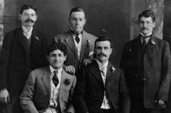 caption: A group portrait of Sephardic pioneers to Seattle, circa 1918. Back, left to right: Mashon (Patatel) Eskenazi, Jacob Policar and Moshan Adatto; front, left to right: Nessim Alhadeff and Solomon (Sam) Calvo.