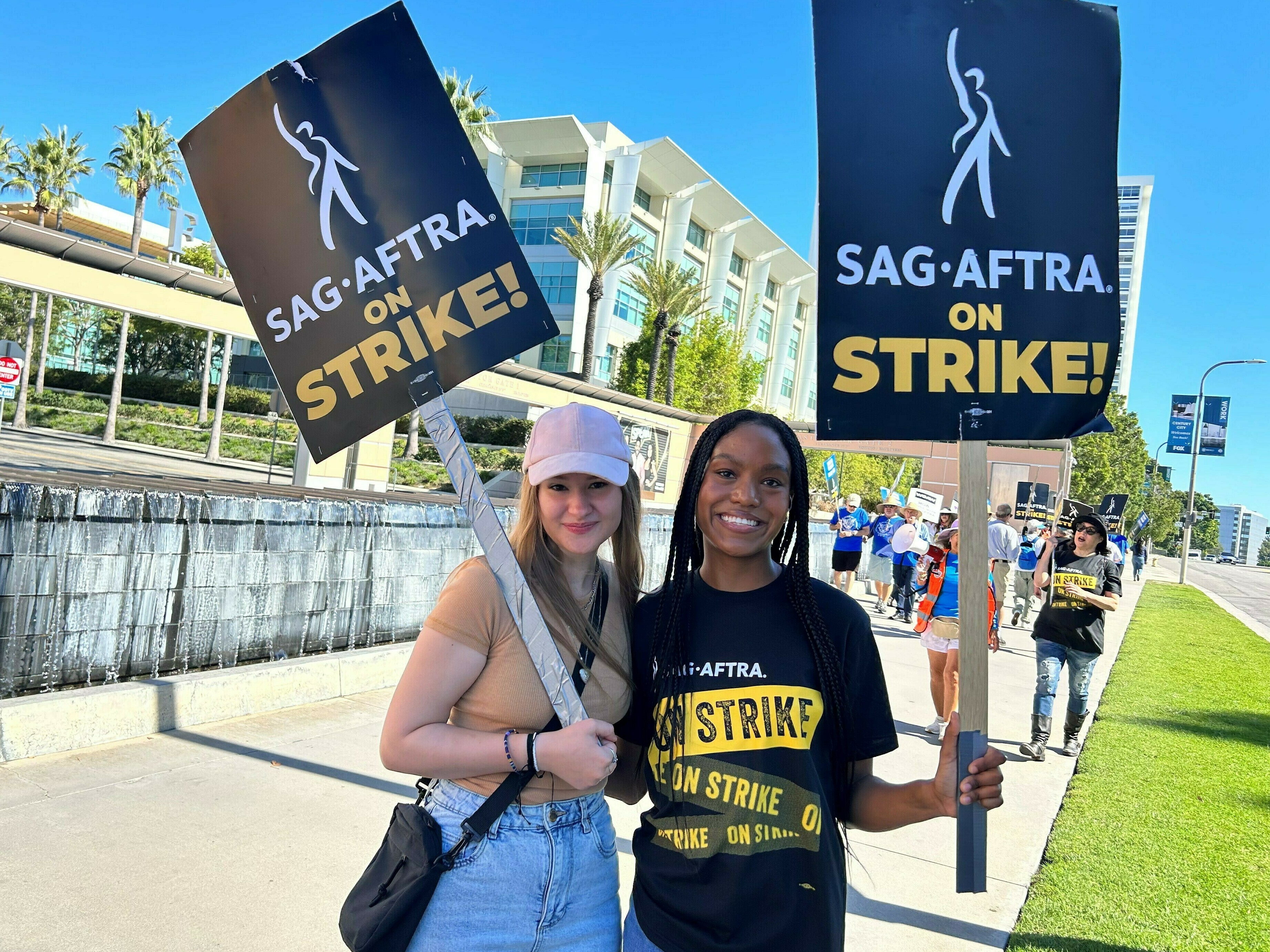 caption: Outside Fox studios in Los Angeles, production assistant Allie Palm and SAG-AFTRA actress Desiree Woolfolk say they can't wait to get back to work.