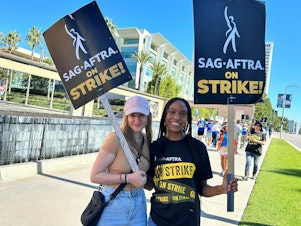 caption: Outside Fox studios in Los Angeles, production assistant Allie Palm and SAG-AFTRA actress Desiree Woolfolk say they can't wait to get back to work.