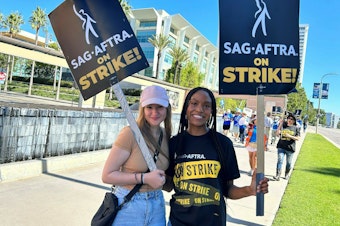 caption: Outside Fox studios in Los Angeles, production assistant Allie Palm and SAG-AFTRA actress Desiree Woolfolk say they can't wait to get back to work.