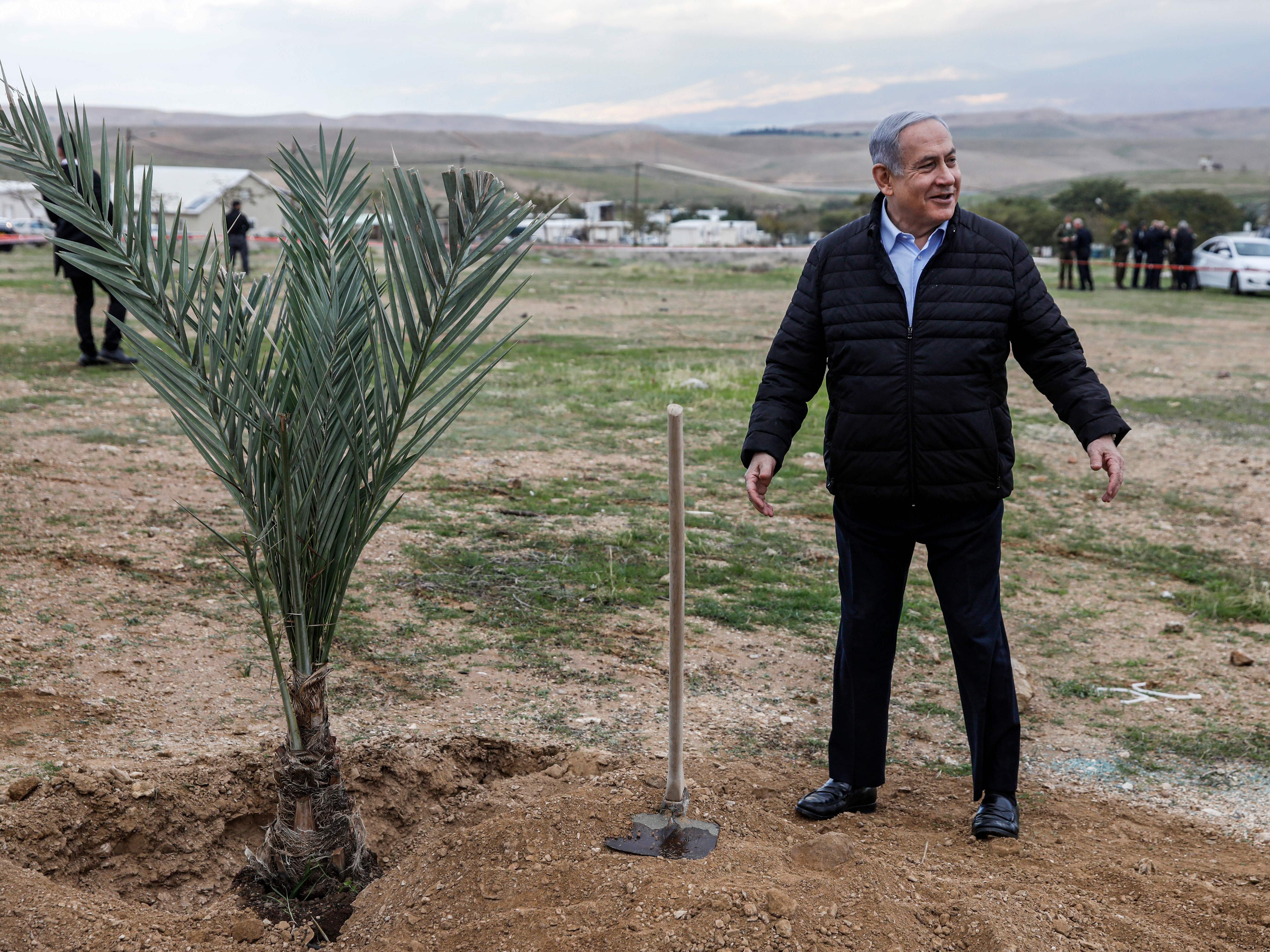 caption: Israeli Prime Minister Benjamin Netanyahu plants a tree during a commemoration of the Jewish holiday of Tu BiShvat (New Year for Trees), in the Israeli settlement of Mevo'ot Yericho near the Palestinian city of Jericho in the Jordan Valley in the occupied West Bank.