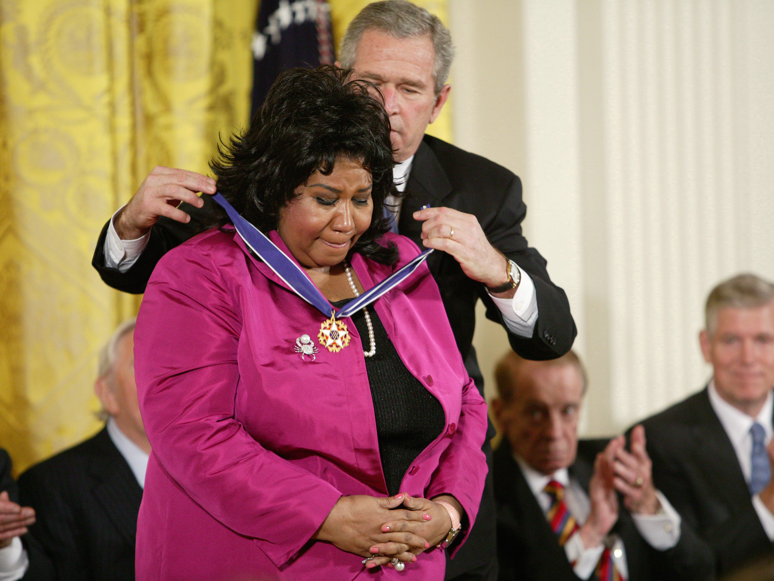 caption: George W. Bush awards Franklin the Presidential Medal of Freedom at the White House in 2005.
