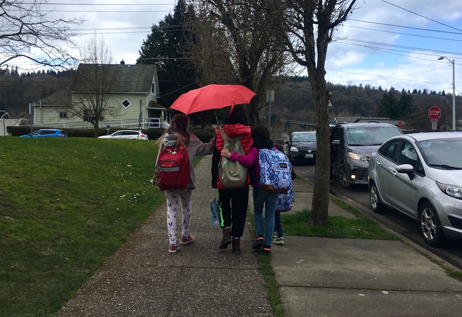 caption: Students outside Concord International Elementary in Seattle comfort each other after hearing about school closures due to the coronavirus outbreak March 11, 2020. 