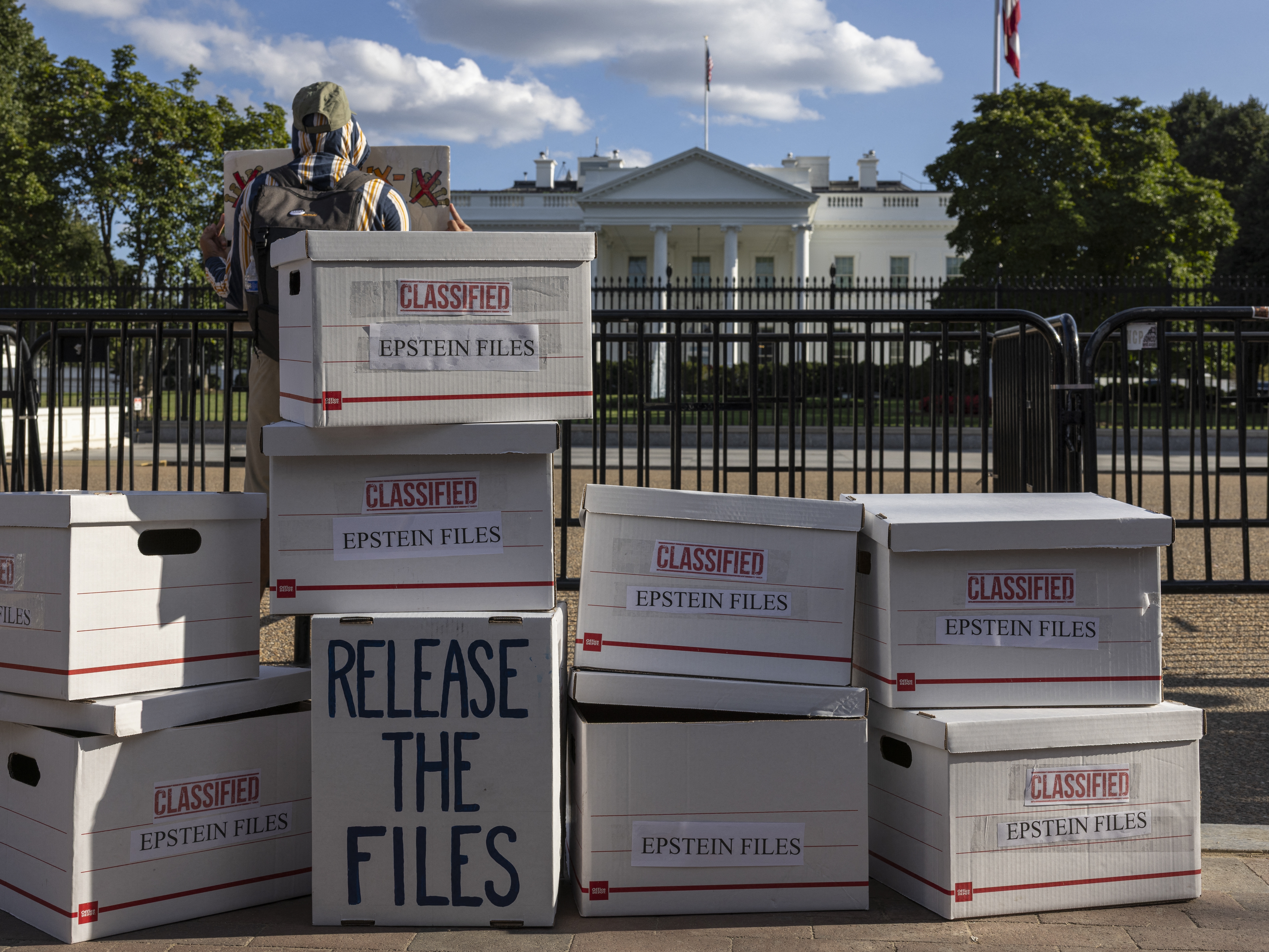 caption: During an anti-Trump protest outside the White House in Washington, D.C., on Sept. 2, 2025, demonstrators set up file boxes to represent the Epstein files. On Wednesday, President Trump signed the legislation directing the Department of Justice to release those files.