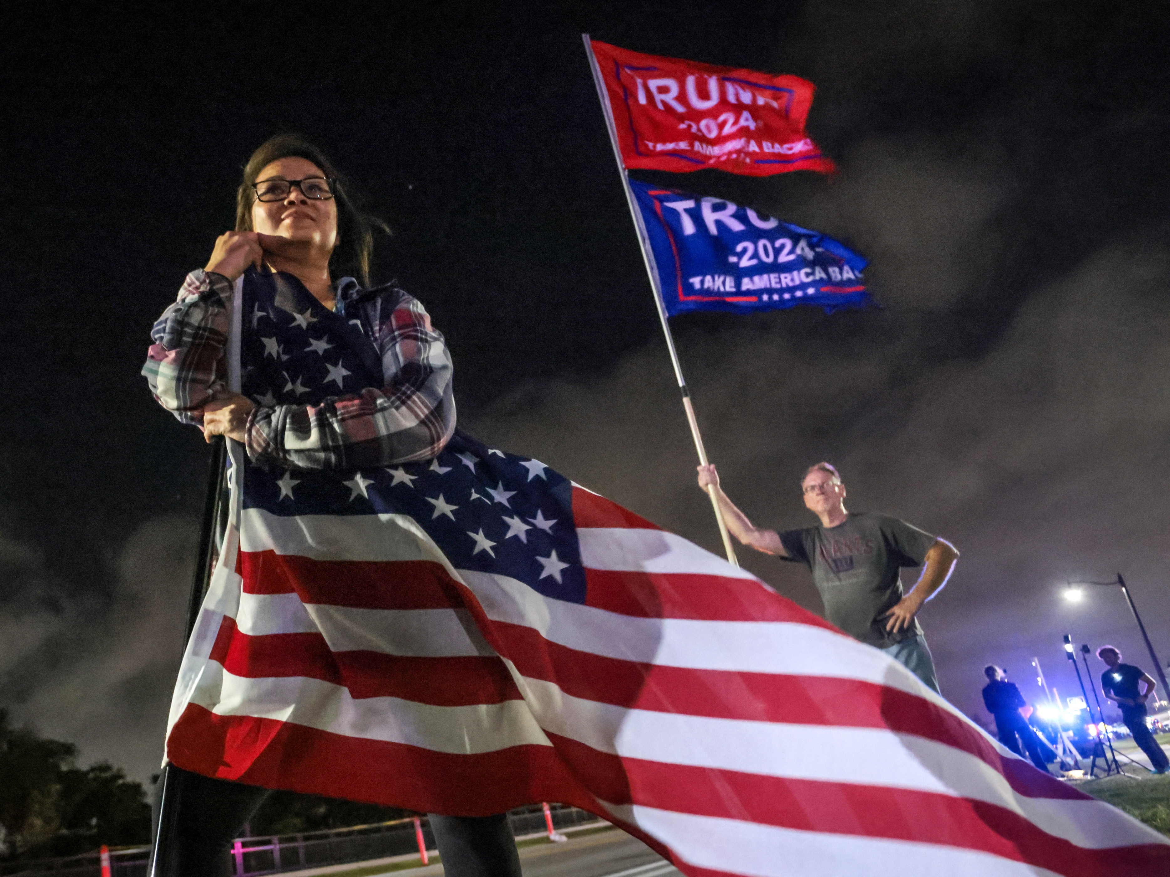 caption: Supporters of Donald Trump gather near his Mar-a-Lago resort in Palm Beach, Florida, on Election Day.