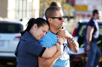 caption: Parents Mabel Fontanilla and Raul Villalonga embrace following a shooting at the University of Nevada, Las Vegas, campus in Las Vegas on Wednesday.