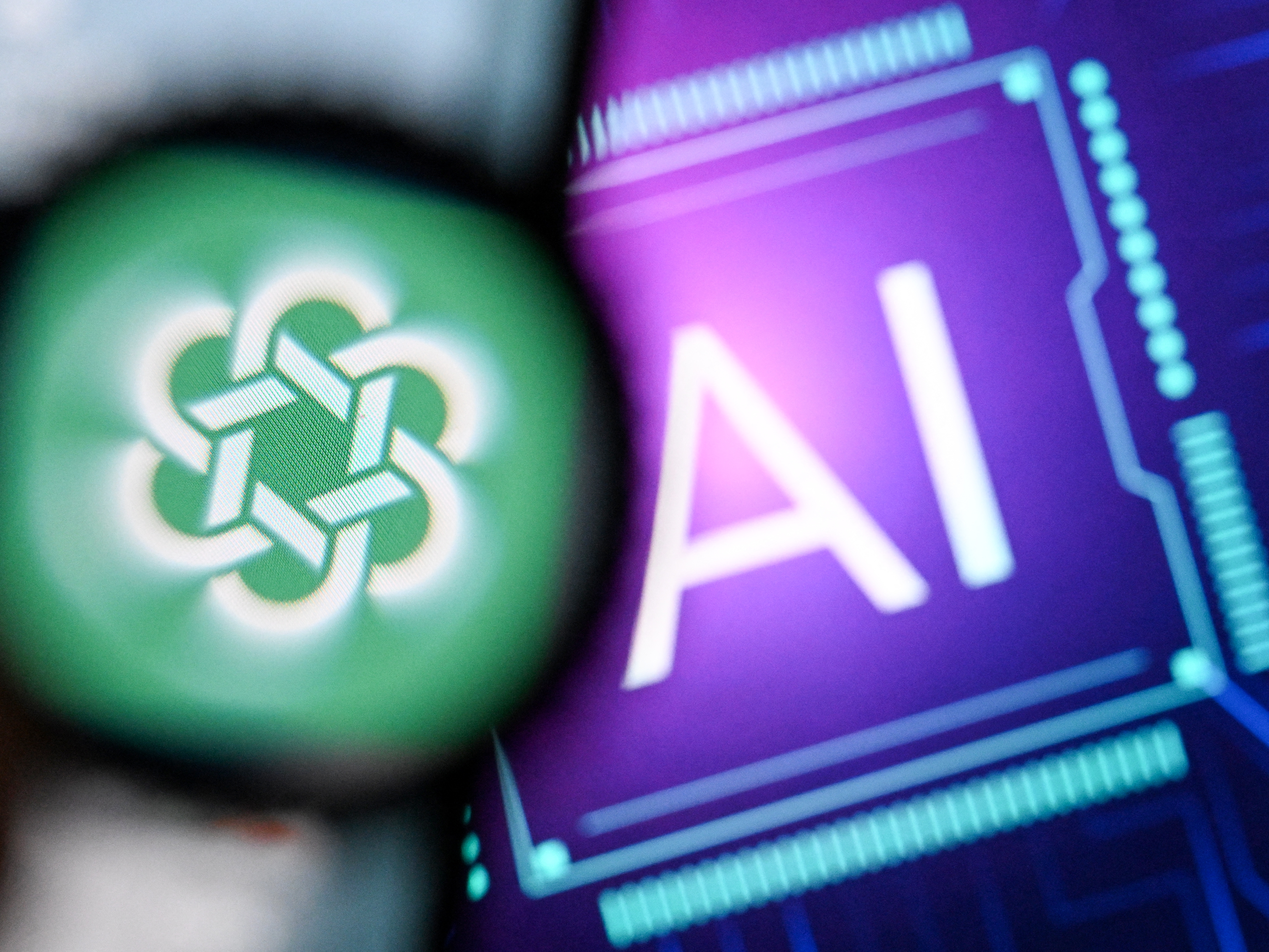 caption: The logo of the ChatGPT application developed by U.S. artificial intelligence research organization OpenAI on a smartphone screen and the letters "AI" on a laptop screen.