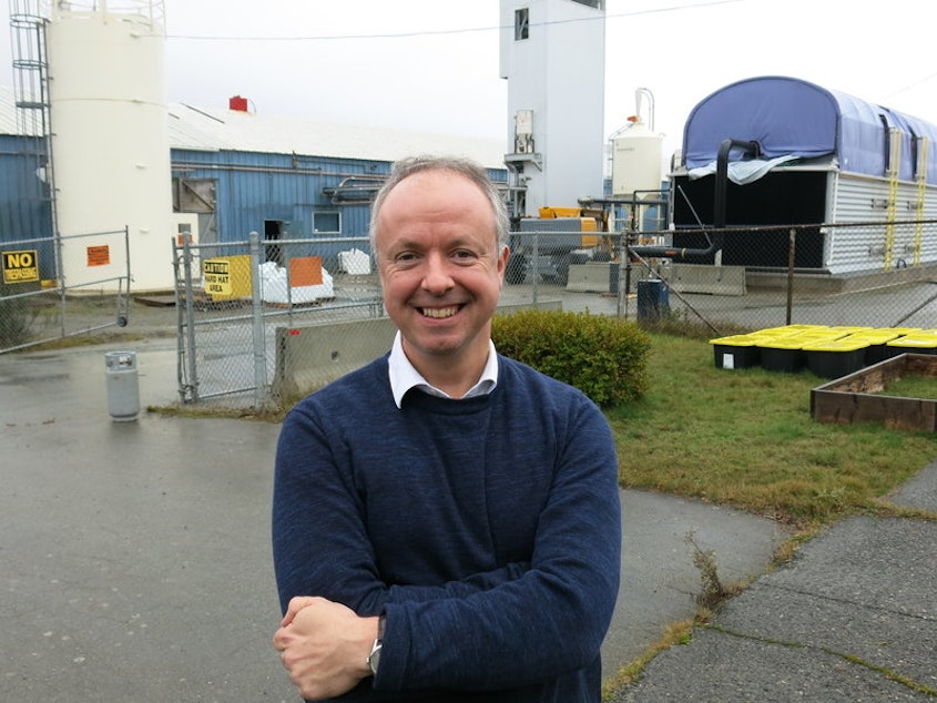 caption: Carbon Engineering CEO Steve Oldham stands in front of the company's Squamish, British Columbia, pilot plant. It uses a chemical process to extract carbon dioxide from the air and turn it into a fuel similar to crude oil.CREDIT: JEFF BRADY/NPR