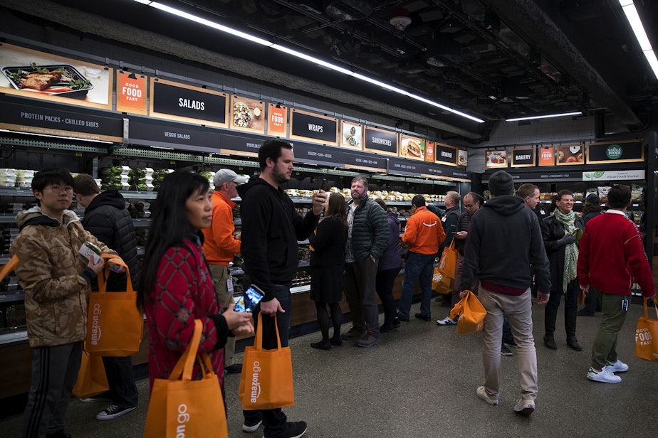 caption: Customers shop at Amazon Go on Monday, January 22, 2018, on 7th Ave., in Seattle. 