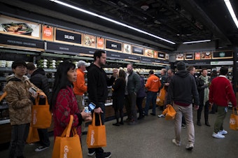 caption: Customers shop at Amazon Go on Monday, January 22, 2018, on 7th Ave., in Seattle. 