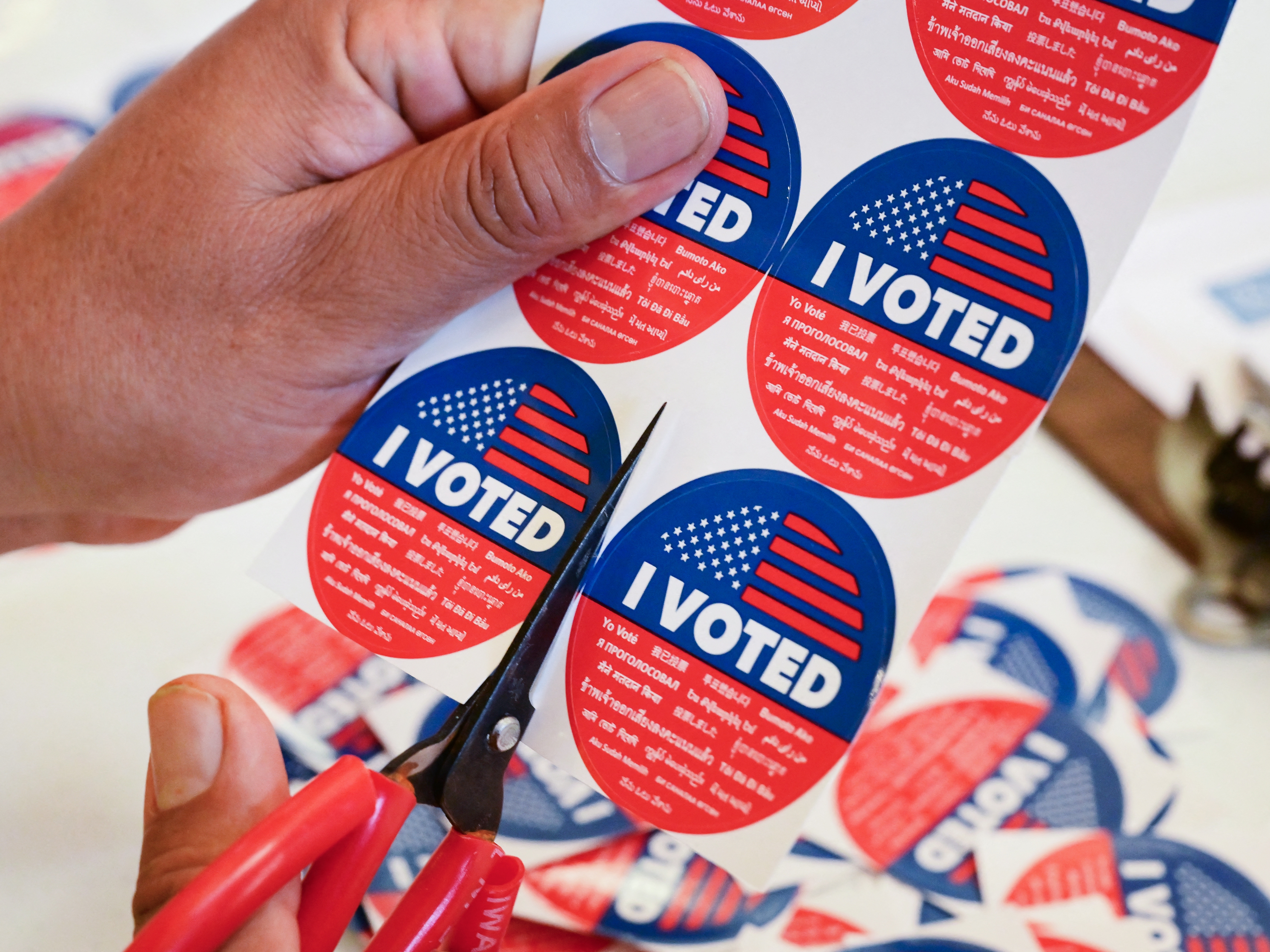 caption: "I Voted" stickers are being prepared at a vote center in Los Angeles, on November 4, 2025, where where Proposition 50 passed as the only measure in the state's special election. Beyond California, lower profile statewide and down ballot races handed Democrats wins the party hopes will extend its momentum into the 2026 midterms.