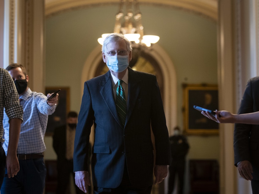 caption: Senate Majority Leader Mitch McConnell walks back to his office after delivering opening remarks at the U.S Capitol on Wednesday.
