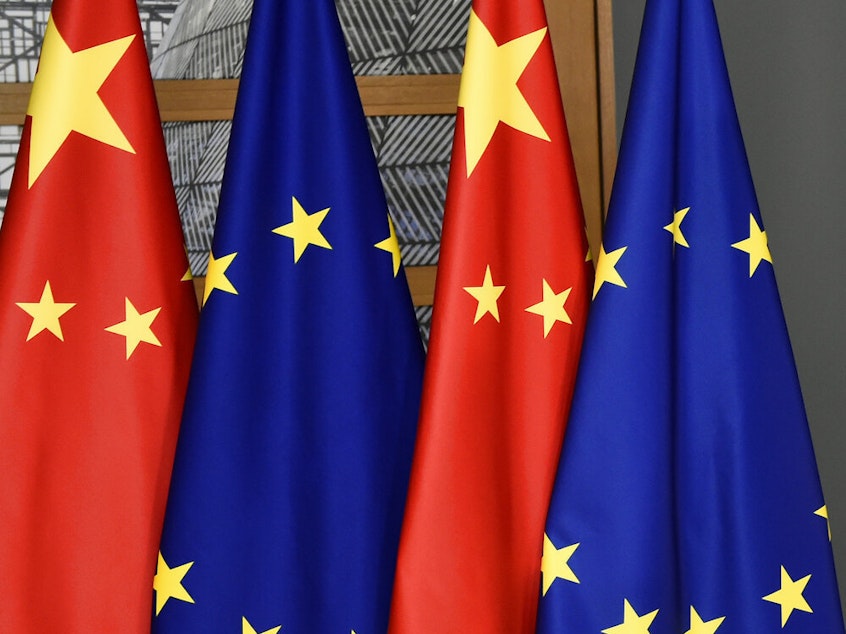 caption: FILE - EU and Chinese flags are seen at the Europa building in Brussels, Tuesday, Dec. 17, 2019 (John Thys/Pool Photo via AP, File)