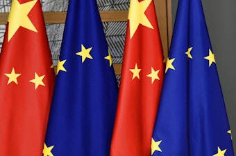 caption: FILE - EU and Chinese flags are seen at the Europa building in Brussels, Tuesday, Dec. 17, 2019 (John Thys/Pool Photo via AP, File)