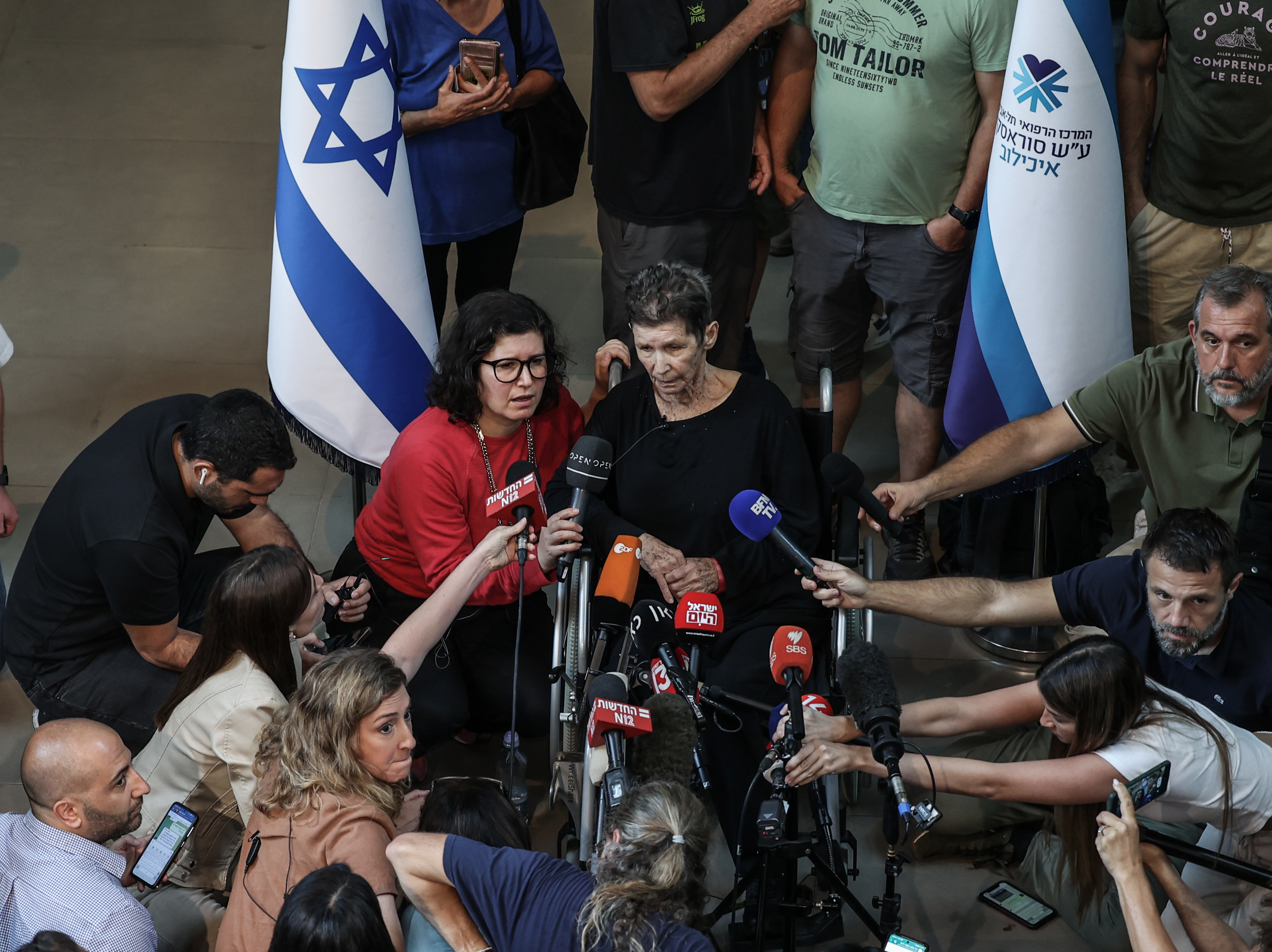 caption: Yocheved Lifshitz, a freed hostage, speaks to media in front of Ichilov Hospital in Israel on Oct. 24, after she was released by Hamas from the Gaza Strip.