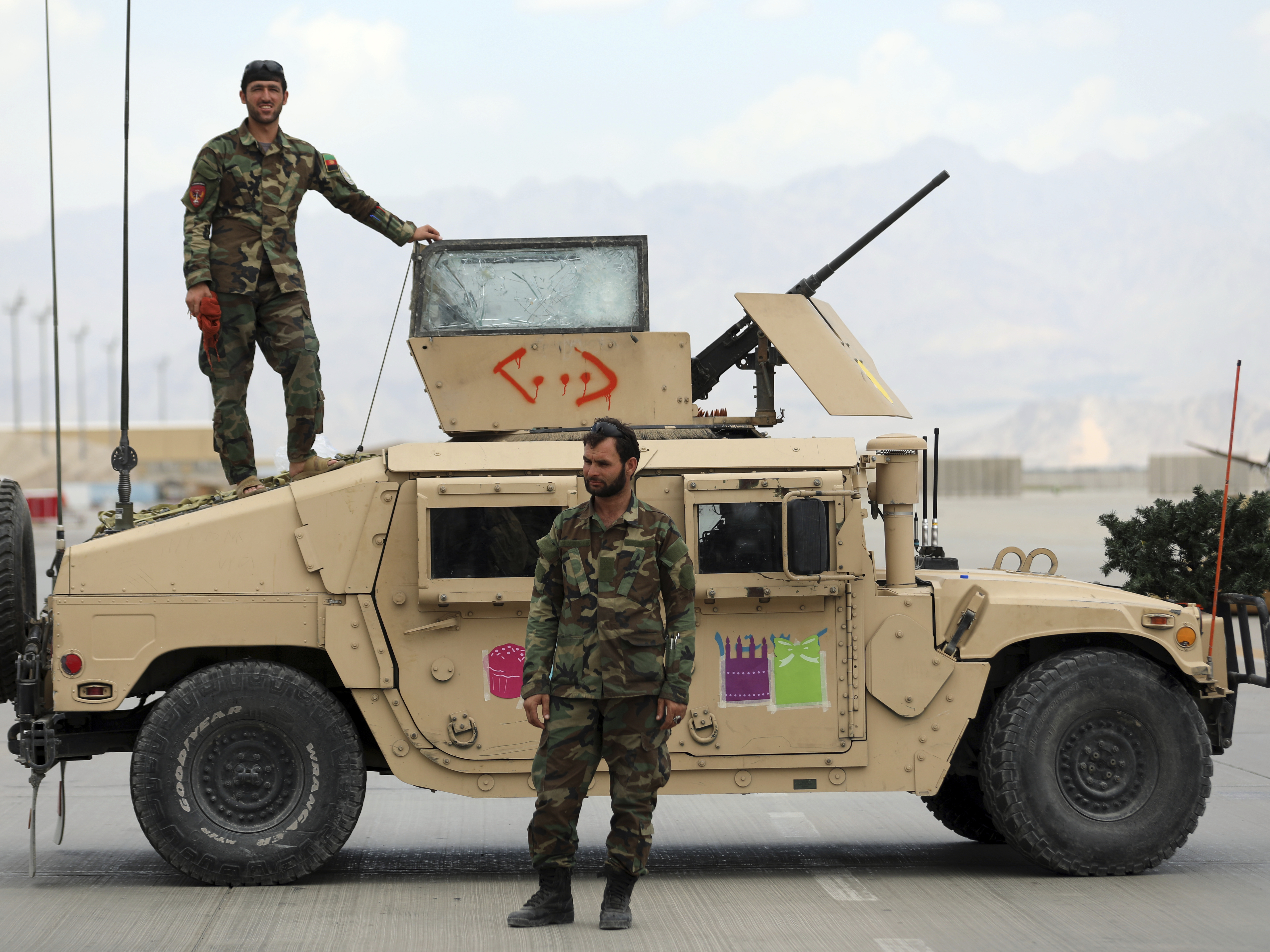 caption: Afghan soldiers stand guard after the American military left the Bagram Air Base, north of Kabul, on July 5. While the U.S. military is now largely gone from Afghanistan, the CIA is still monitoring the Taliban and developments in the country, though under much more difficult circumstances.