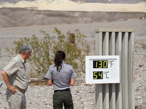 caption: Visitors feel the heat in California's Death Valley earlier this week. This record-setting heat wave's remarkable power, reach and unusually early appearance is giving meteorologists yet more cause for concern about extreme weather in an era of climate change.